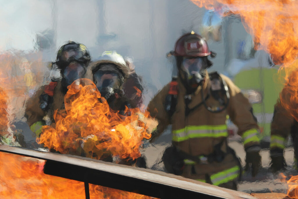 Firefighters extinguishing fires in extreme heat with compressed air foam